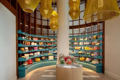 a store with chandeliers and cakes on shelves at Conrad Orlando in Orlando