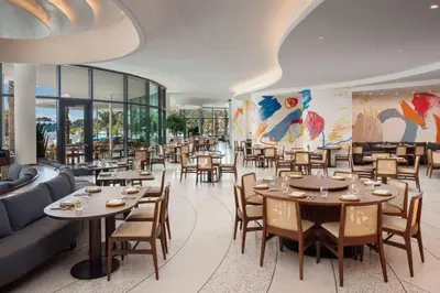 a restaurant with tables and chairs and a couch at Conrad Orlando in Orlando