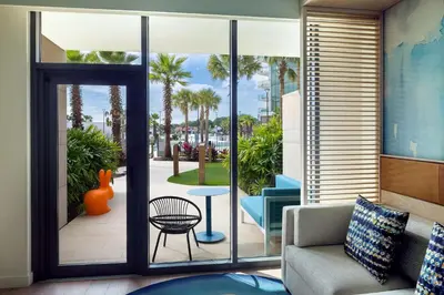 a living room with a door open to a patio at Conrad Orlando in Orlando