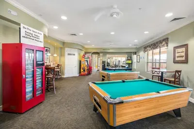 a billiard room with a pool table and a machine at Resort Condo in Kissimmee about 3 Mi to Disney! in Orlando