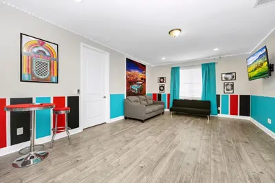 a living room with a couch and a table at Alluring Home Near Disney With Themed, Media And Game Room With Waterpark & Resort Access At Encore Resorts Reunion - 232Au in Kissimmee
