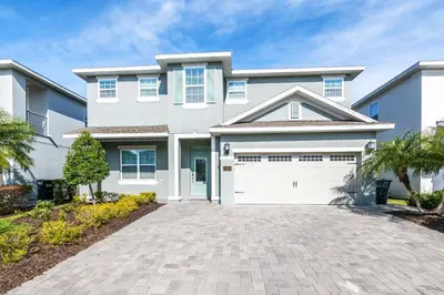 a large white house with a driveway at Modern Home With Private Pool Near Disney With Waterpark & Resort Access At Encore Resort - 7655Ff in Kissimmee