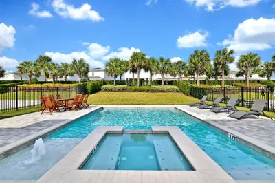 a swimming pool with chairs and a table and trees at Modern Home With Private Pool Near Disney With Waterpark & Resort Access At Encore Resort - 7655Ff in Kissimmee