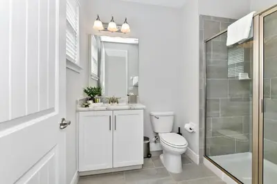 a bathroom with a toilet and a sink and a shower at Modern Home With Private Pool Near Disney With Waterpark & Resort Access At Encore Resort - 7655Ff in Kissimmee
