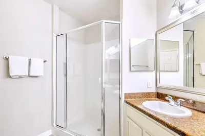 a bathroom with a shower and a sink at 3BR Condo with Pool - Near Disney in Orlando