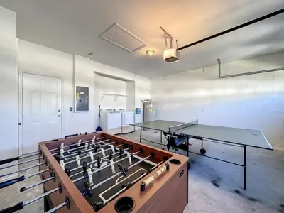 a room with two tables and a stove in it at Luxury 6BD 3,5BA Pool Home in Windsor Palms Resort villa in Kissimmee