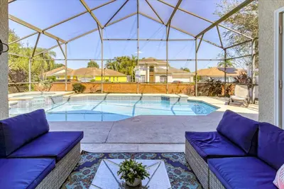 a large swimming pool with a glass roof at Large Home-Private Pool, Spa, and Pet Friendly Sleeps 12 in Orlando