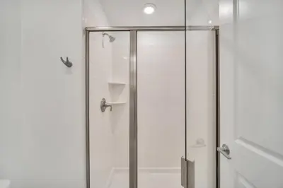 a shower with a glass door in a bathroom at Amazing Story Lake Town Home With Pool townhouse in Kissimmee