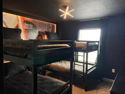 a room with two bunk beds and a ceiling fan at Amazing Story Lake Town Home With Pool townhouse in Kissimmee