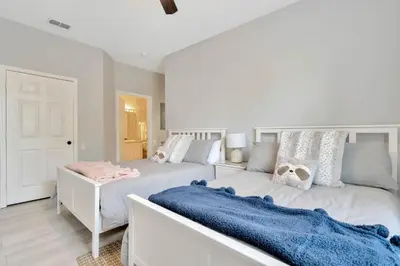 a bedroom with two beds with blue blankets at Windsor Hills Resort Poolside Ground Floor 3 Bed Condo in Orlando