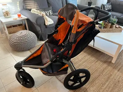an orange and black stroller in a living room at Windsor Hills Resort Poolside Ground Floor 3 Bed Condo in Orlando