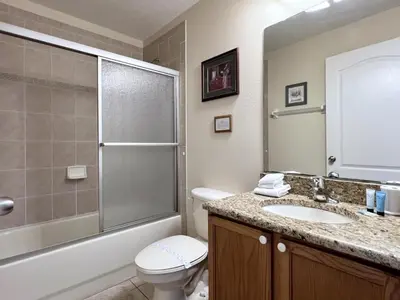 a bathroom with a toilet and a sink and a shower at Lovely Lakeside 4-Bed Pool Home at Villa Sol-3125 home in Kissimmee