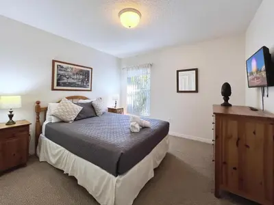 a bedroom with a bed and a television in it at Lovely Lakeside 4-Bed Pool Home at Villa Sol-3125 home in Kissimmee