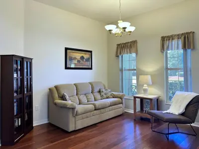a living room with a couch and a chair at Lovely Lakeside 4-Bed Pool Home at Villa Sol-3125 home in Kissimmee