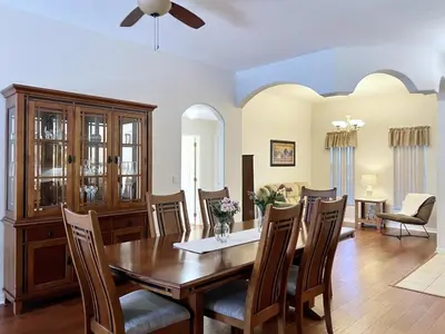a dining room with a table and chairs at Lovely Lakeside 4-Bed Pool Home at Villa Sol-3125 home in Kissimmee