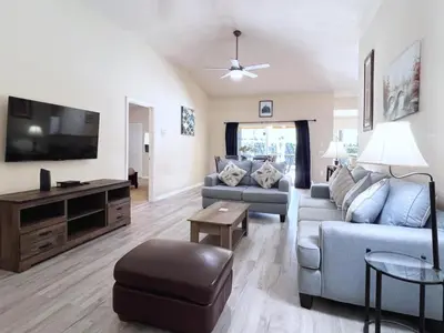 a living room with a couch and a tv at Lovely 3-Bedroom Pool Villa-1445SCD villa in Orlando