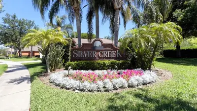 a sign at the entrance to a resort with flowers at Lovely 3-Bedroom Pool Villa-1445SCD villa in Orlando