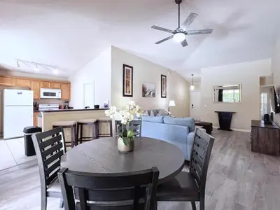 a kitchen and living room with a table and a couch at Lovely 3-Bedroom Pool Villa-1445SCD villa in Orlando