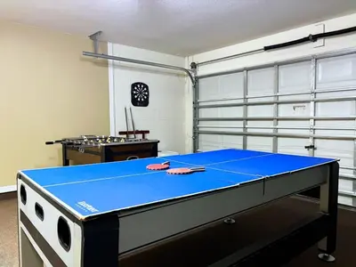 a blue ping pong table in a room at Cozy 4 Bed 3 Bath Pool Hm with Game Room-4450NP home in Kissimmee
