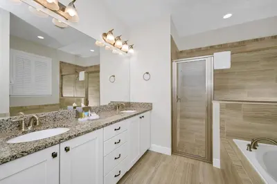 a bathroom with two sinks and a shower at Inviting Home Near Disney With Private Pool And Waterpark & Resort Access At Encore Resorts Reunion - 7578Mr in Kissimmee