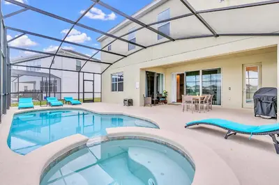 a swimming pool with a glass roof at 6BR Luxury Home w Pool Hot Tub and Games room in Kissimmee