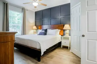a bedroom with a large bed with a large headboard at Mickey's Welcome Inn - Closest Resort to Disney in Orlando