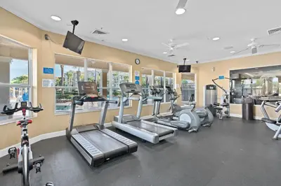 a gym with several treadmills and cardio machines at Mickey's Welcome Inn - Closest Resort to Disney in Orlando