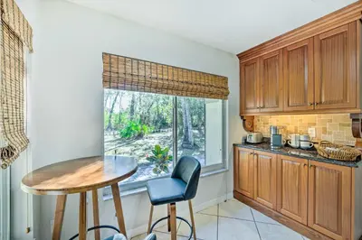a kitchen with a small table and a window at Walk to Lake Stunning Central Florida Home! in Lake Mary