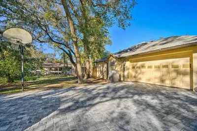 a garage with a basketball hoop next to a building at Walk to Lake Stunning Central Florida Home! in Lake Mary