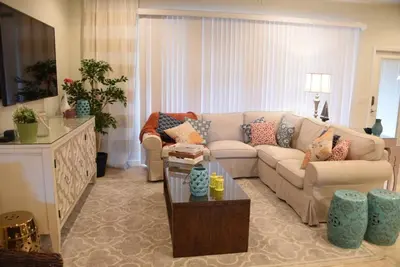 a living room with a couch and a table at Gorgeous 4Bd TH Pool Windsor at Westside-2018WW home in Orlando