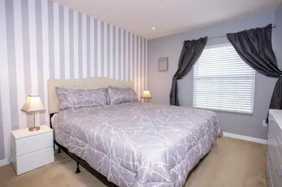 a bedroom with a large bed and a window at Amazing 3 Bdrms At Encantada- 6 miles from Disney in Kissimmee