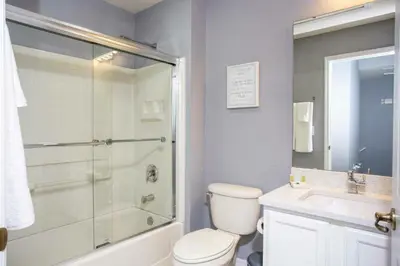 a bathroom with a shower and a toilet and a sink at Amazing 3 Bdrms At Encantada- 6 miles from Disney in Kissimmee