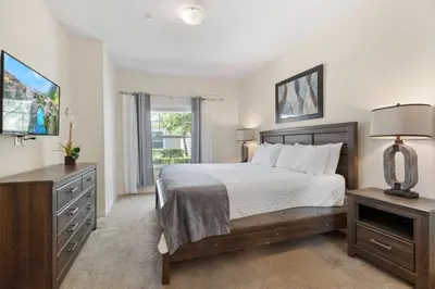 a bedroom with a bed and a dresser and a window at Amazing 3 bedrooms At Lucaya- 7 miles from Disney in Kissimmee