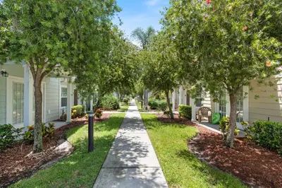 a walkway through a residential neighborhood with trees at Amazing 3 bedrooms At Lucaya- 7 miles from Disney in Kissimmee