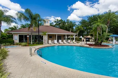 a swimming pool in front of a house at Amazing 3 bedrooms At Lucaya- 7 miles from Disney in Kissimmee