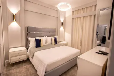 a bedroom with a large bed and a mirror at New Home 8 Bedrooms and 5 Bathrooms At Storey Lake in Kissimmee