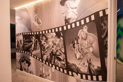 a wall with a bunch of pictures on it at New Home 8 Bedrooms and 5 Bathrooms At Storey Lake in Kissimmee