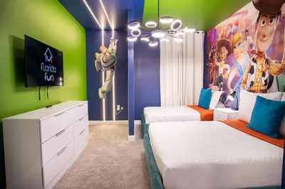 a bedroom with two beds and a mural of goofy at New Home 8 Bedrooms and 5 Bathrooms At Storey Lake in Kissimmee