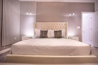 a bedroom with a large white bed with two pillows at New Home 8 Bedrooms and 5 Bathrooms At Storey Lake in Kissimmee