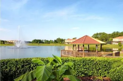 a gazebo next to a lake with a fountain at Amazing 3 Bdrm At Encantada- 6 miles from Disney in Kissimmee