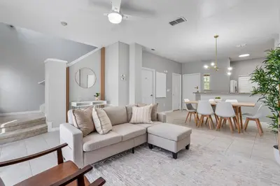 a living room with a couch and a dining room at Amazing 3Bdrms At Encantada -6 miles from Disney in Kissimmee