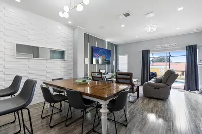 a dining room with a wooden table and chairs at Cozy 3Bdrms At Encantada- 6 miles from Disney in Kissimmee