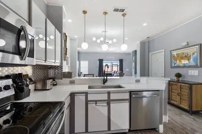 a kitchen with white counter tops and a sink at Cozy 3Bdrms At Encantada- 6 miles from Disney in Kissimmee