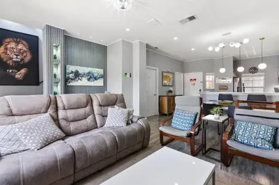 a living room with a couch and a kitchen at Cozy 3Bdrms At Encantada- 6 miles from Disney in Kissimmee