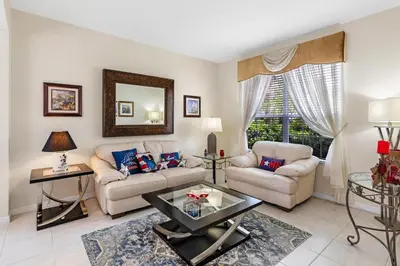 a living room with a couch and a table at Family Friendly Emerald Island Resort Vacation Home with Private Pool and Spa Near Disney in Kissimmee