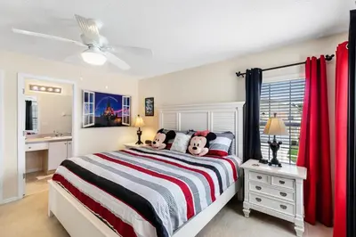 a bedroom with a bed and a ceiling fan at Family Friendly Emerald Island Resort Vacation Home with Private Pool and Spa Near Disney in Kissimmee