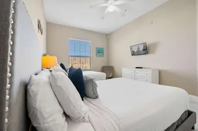 a bedroom with a white bed and a window at 4804 Cayview Avenue 401 in Orlando