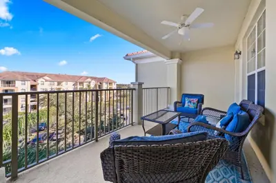 a balcony with two chairs and a table on a balcony at 4804 Cayview Avenue 401 in Orlando