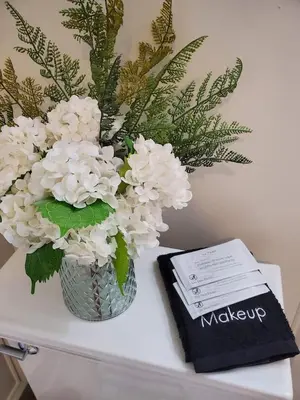 a vase of white flowers sitting on top of a table at Remodeled 2BD/2BA Condo mins from Universal Studio in Orlando