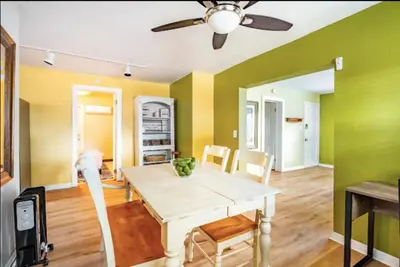 a dining room with a table and a ceiling fan at 3-Bed Bungalow walk to Historic Downtown Sanford in Sanford